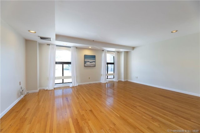 empty room with recessed lighting, light wood-style floors, visible vents, and baseboards