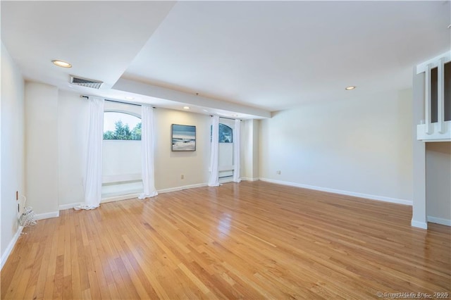 unfurnished living room featuring visible vents, recessed lighting, baseboards, and light wood-style floors