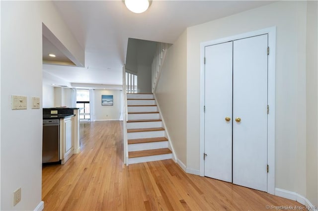 stairs with baseboards and wood finished floors