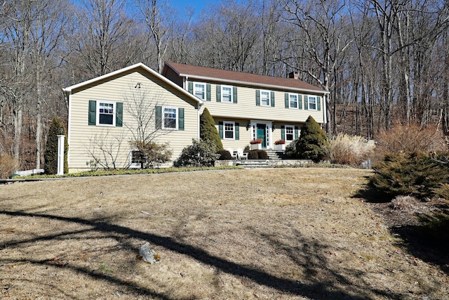 colonial inspired home featuring a chimney