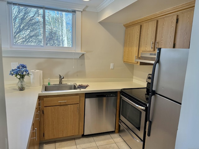 kitchen featuring under cabinet range hood, a sink, light countertops, ornamental molding, and appliances with stainless steel finishes