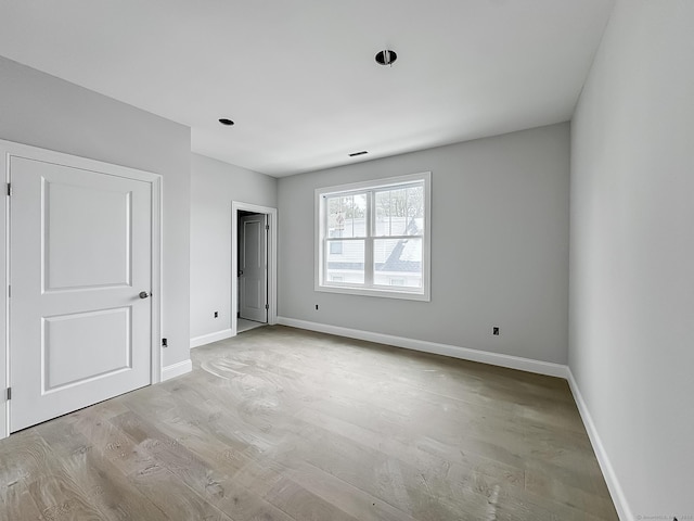 unfurnished bedroom with light wood-type flooring