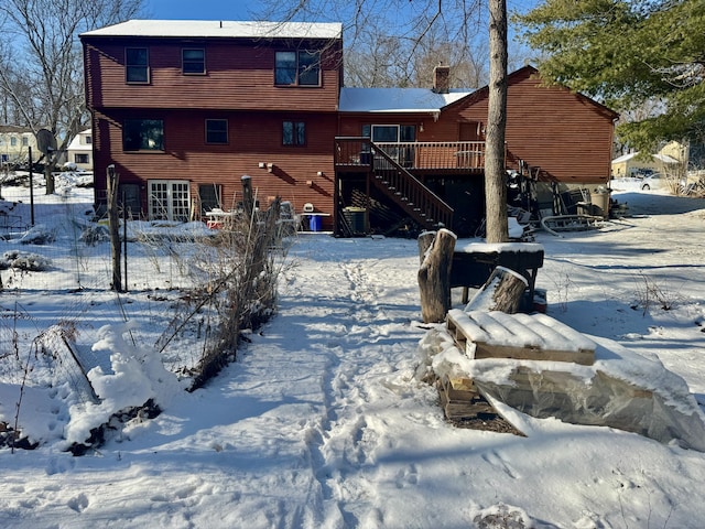 snow covered property featuring a wooden deck