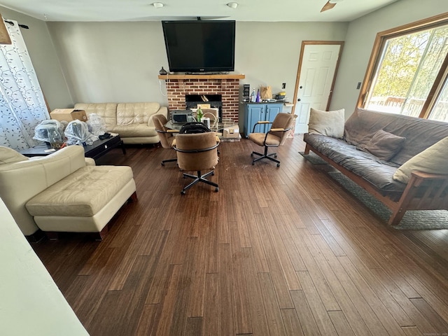 living room with a fireplace and dark hardwood / wood-style flooring