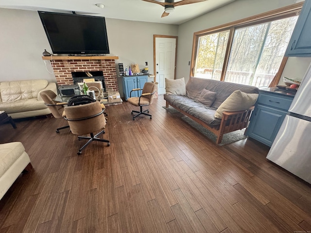 living room featuring ceiling fan and dark wood-type flooring