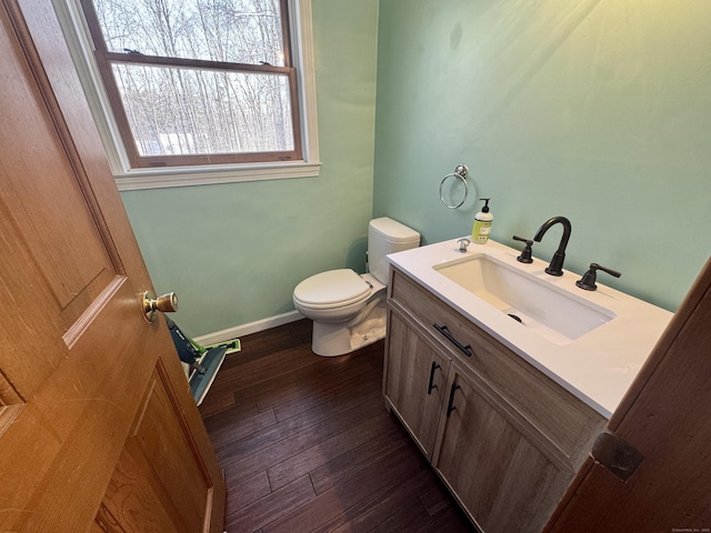 bathroom with vanity, toilet, and hardwood / wood-style floors