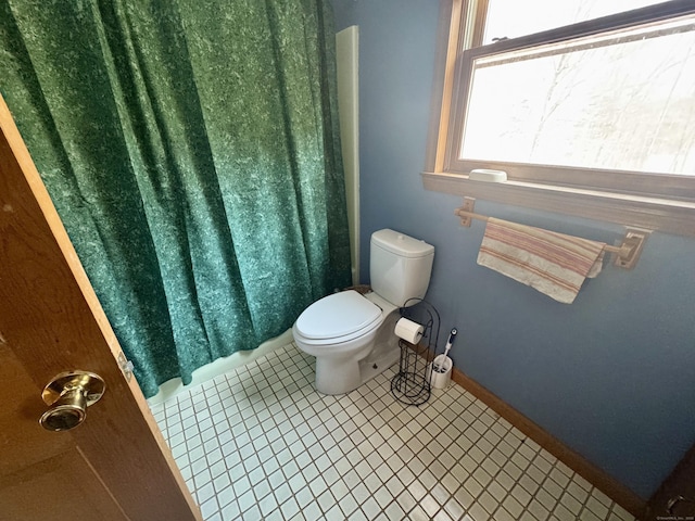 bathroom with toilet and tile patterned flooring