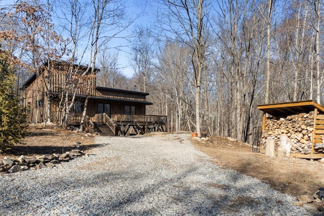 view of side of property featuring gravel driveway