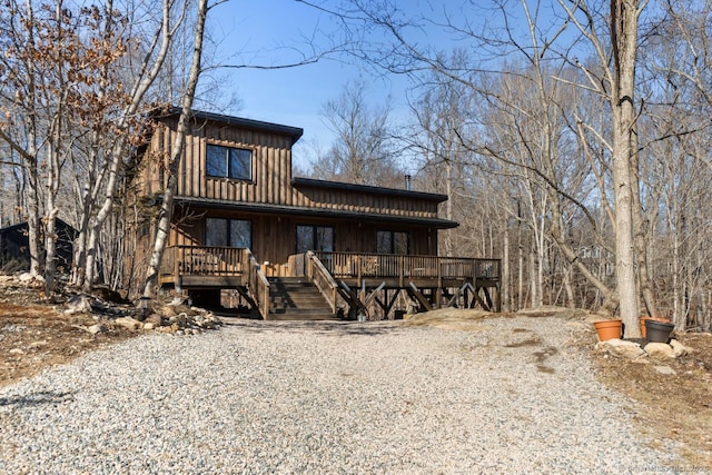 view of front of house featuring board and batten siding and a wooden deck