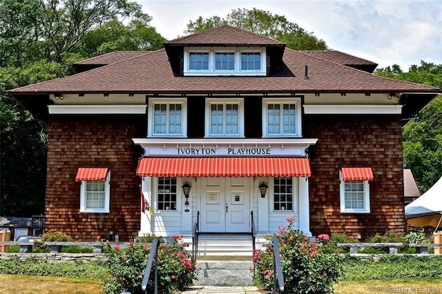 view of front of property featuring roof with shingles