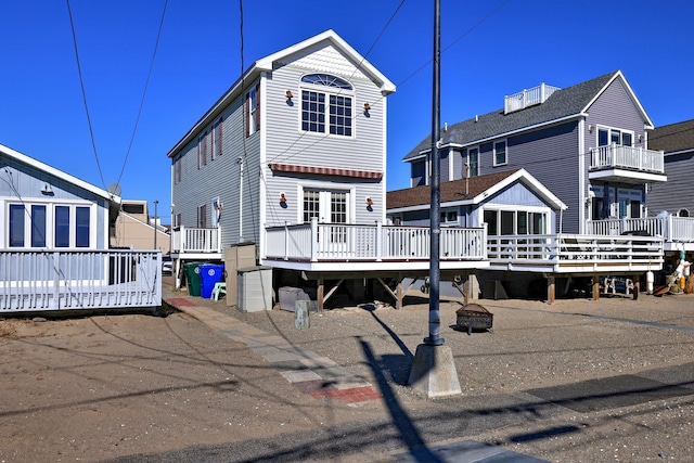 rear view of property featuring a deck