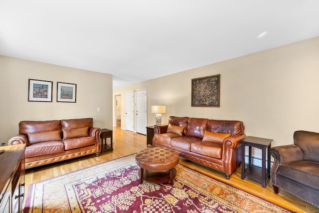 living area with a baseboard heating unit and wood finished floors