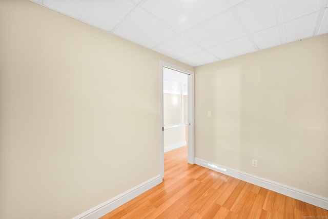 unfurnished room featuring light wood-type flooring and baseboards