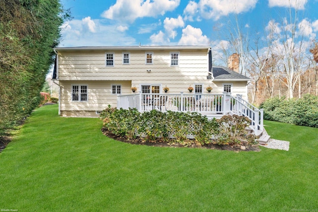 back of house with a yard, a chimney, and a wooden deck