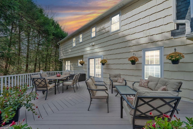 wooden terrace featuring an outdoor living space and outdoor dining space