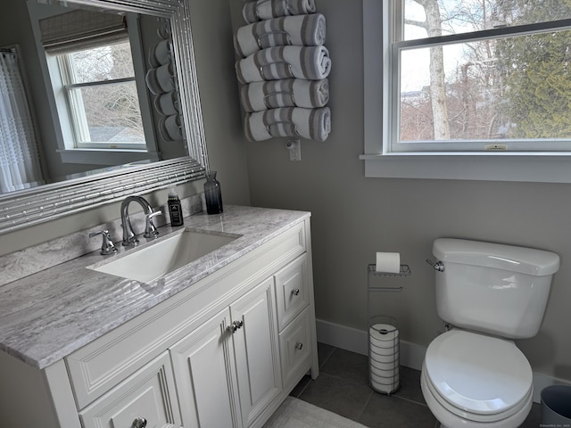 bathroom featuring toilet, tile patterned flooring, and vanity