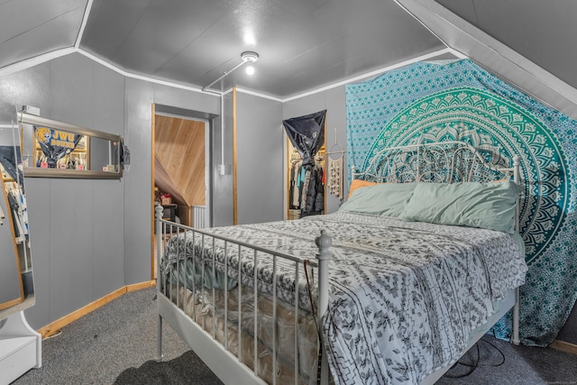 bedroom with carpet floors, ornamental molding, and vaulted ceiling