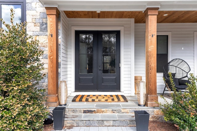 property entrance featuring french doors and covered porch