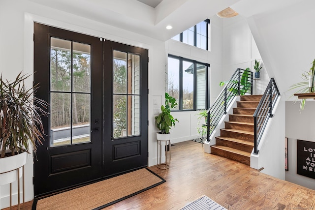 foyer featuring a wealth of natural light, french doors, and wood finished floors