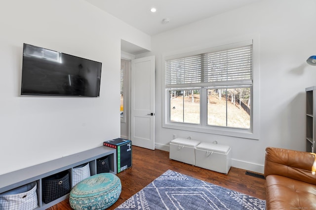 living room featuring recessed lighting, wood finished floors, visible vents, and baseboards