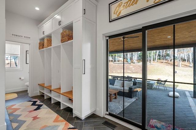 mudroom with dark tile patterned floors, recessed lighting, visible vents, and baseboards