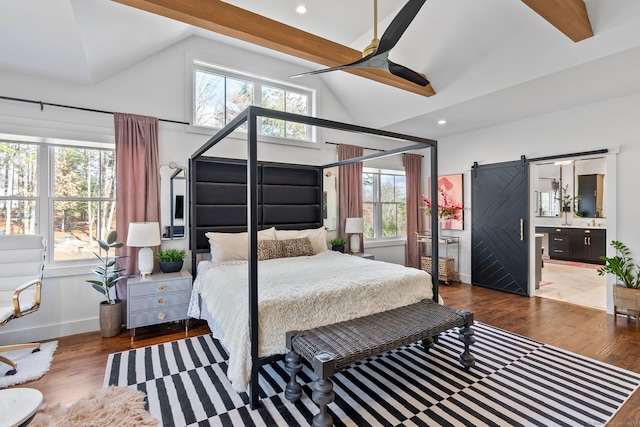 bedroom with a barn door, high vaulted ceiling, beamed ceiling, and wood finished floors