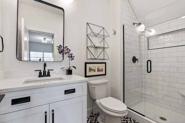 full bathroom with a shower stall, toilet, and vanity