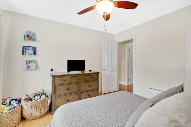 bedroom with a ceiling fan and light wood-type flooring