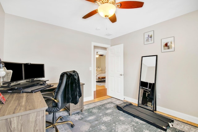 home office with ceiling fan, light wood finished floors, and baseboards