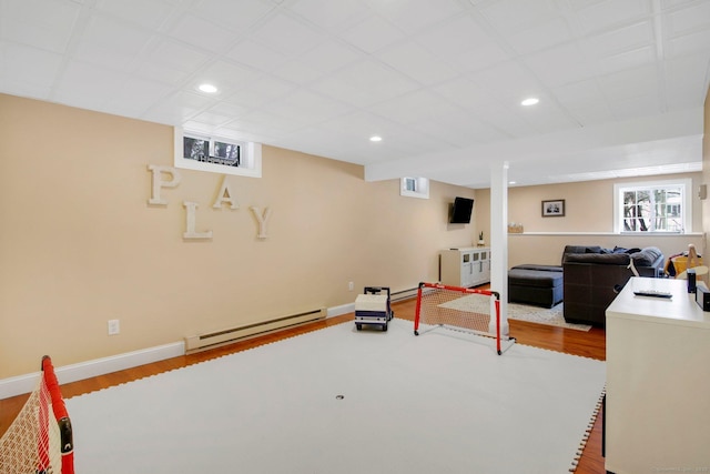 interior space featuring recessed lighting, baseboards, baseboard heating, and wood finished floors