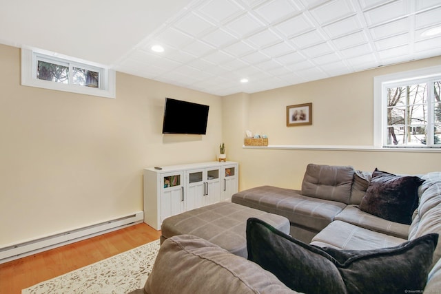 living area featuring a baseboard heating unit, recessed lighting, and wood finished floors