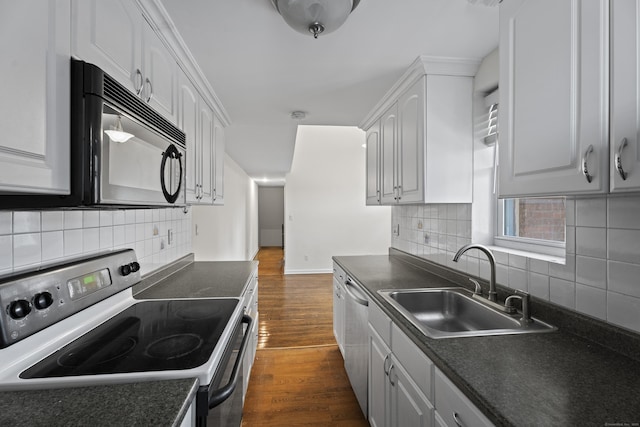 kitchen with black microwave, range with electric stovetop, and white cabinetry