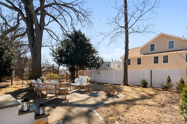 view of yard featuring a patio area, fence, and outdoor lounge area