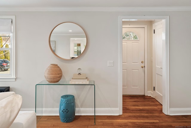 entryway featuring crown molding, baseboards, and wood finished floors