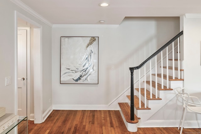 stairway featuring crown molding, baseboards, wood finished floors, and recessed lighting