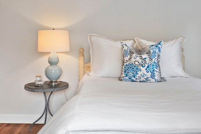 bedroom featuring baseboards and wood finished floors