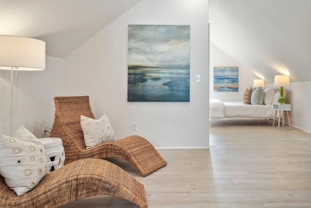 sitting room with lofted ceiling and light wood finished floors