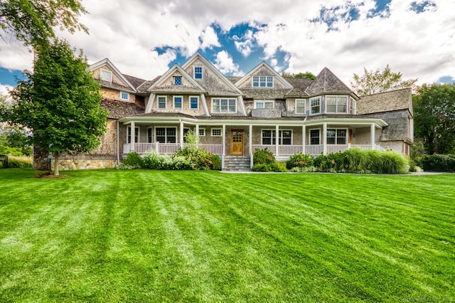 view of front of home featuring covered porch and a front yard