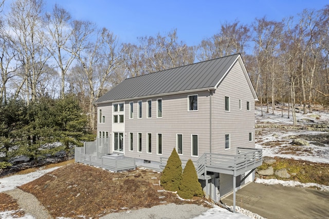 view of snow covered exterior featuring a garage