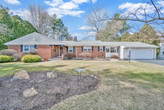 ranch-style home with brick siding, a front lawn, a chimney, a garage, and driveway