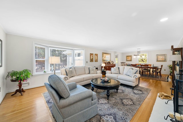 living area featuring light wood-style flooring and baseboards