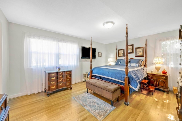 bedroom featuring baseboards and light wood-style floors