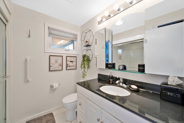 bathroom featuring vanity, baseboards, tile patterned floors, toilet, and a shower with door