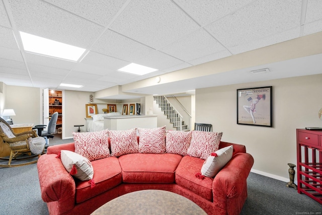 carpeted living area featuring visible vents, stairway, a paneled ceiling, and baseboards