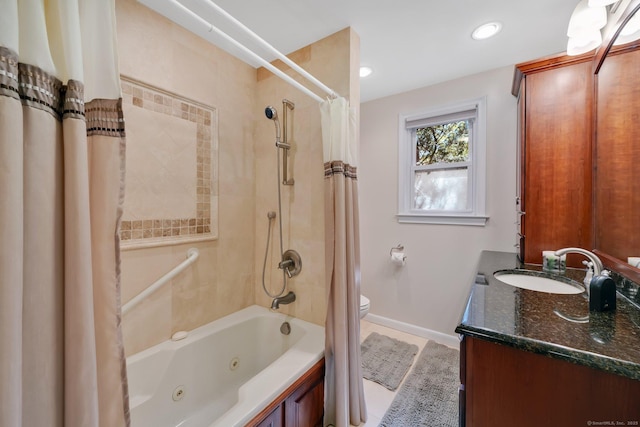 bathroom with vanity, baseboards, recessed lighting, a combined bath / shower with jetted tub, and toilet