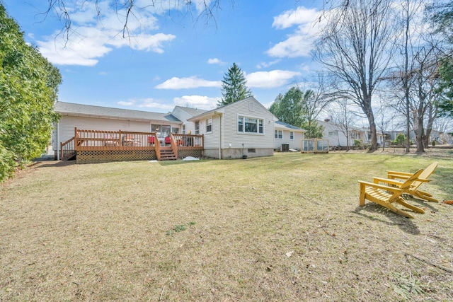 back of house with a yard and a wooden deck