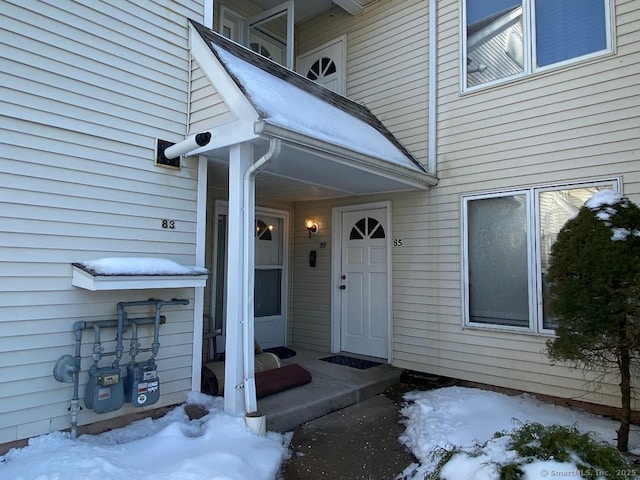 view of snow covered property entrance