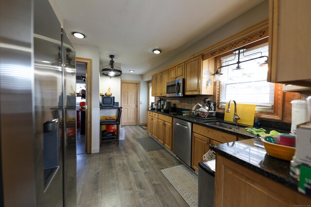 50 Dean Rd, New Milford, CT 06776 - kitchen with stainless steel appliances, a sink, wood finished floors, decorative backsplash, and dark stone counters