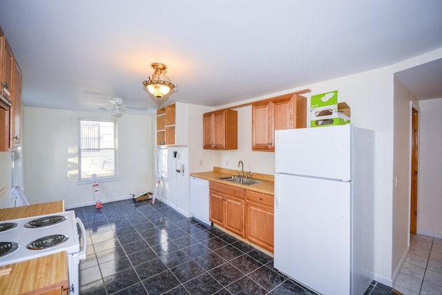 kitchen with light countertops, a ceiling fan, a sink, white appliances, and baseboards