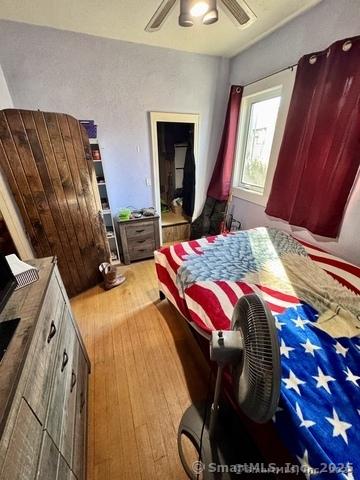 bedroom with ceiling fan and light wood-type flooring